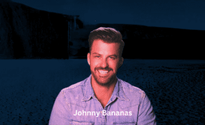 Johnny Bananas enjoying a sunny day at the beach with a clear blue sky above.